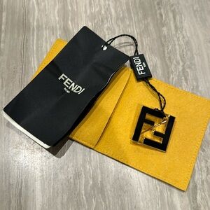 Fendi gold and black enamel brooch.